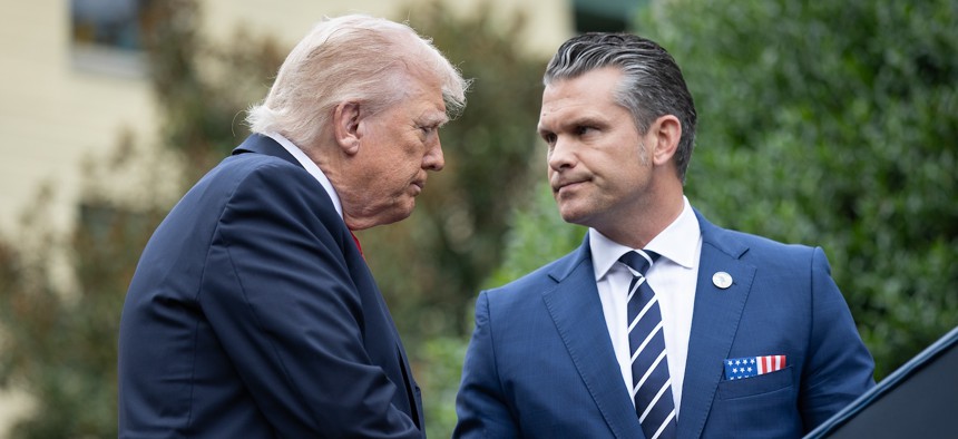 President Donald Trump greets Defense Secretary Pete Hegseth during a September 11th observance event in the courtyard of the Pentagon. 
