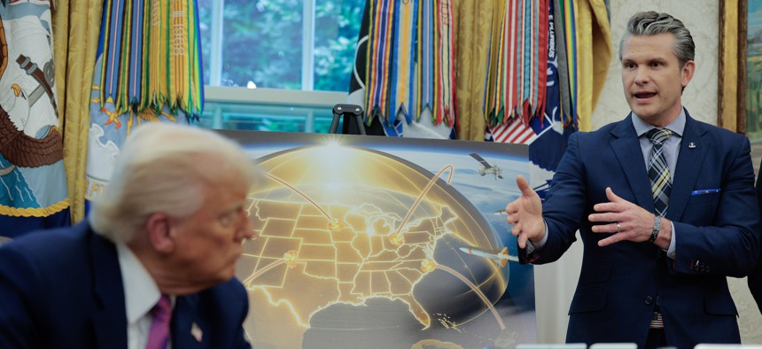 Defense Secretary Pete Hegseth talks about the Golden Dome missile-defense system with President Donald Trump in the Oval Office at the White House on May 20, 2025.