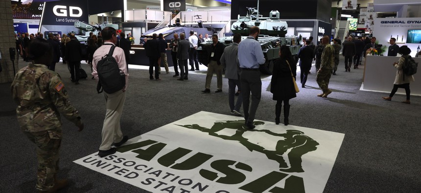 Attendees walk into the Association of the U.S. Army (AUSA) Annual Meeting's exposition hall at the Walter E. Washington Convention Center on October 11, 2023, in Washington, D.C.