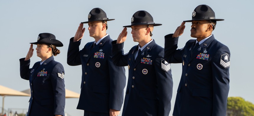Members of the U.S. Air and Space Forces salute during their initiation ceremony as military training instructors, Oct. 17, 2024, in Texas.
