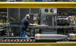 An employee at General Dynamics Scranton moves a mortar along the production line in August 2025.
