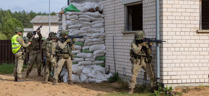 U.S. Army soldiers prepare to breach a building during the Engineer Thunder 2025 exercise in Lithuania on Sept. 11, 2025.