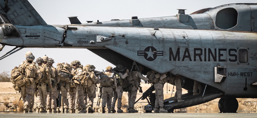 U.S. Marines with the 1st Marine Division board a CH-53E Super Stallion of the 3rd Marine Aircraft Wing during an exercise at Marine Corps Air-Ground Combat Center, Twentynine Palms, California, on Aug. 21, 2025.