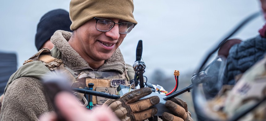 A soldier with the U.S. Army's 4th Air Defense Artillery Regiment examines a downed drone during Project Flytrap on Nov. 19, 2025, at the Trubbenubungsplatz Putlos, Germany.