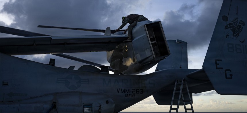 U.S. Marines maintain an MV-22B Osprey on the flight deck of USS Iwo Jima while underway in the Caribbean Sea, Nov. 22, 2025.