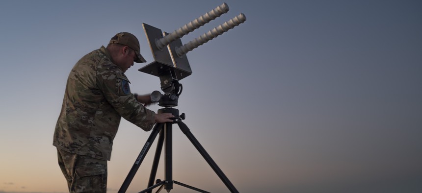 U.S. Space Force Tech Sgt. Kyle Yeager adjusts the tilt of the helical antenna in preparation for training exercise at Cannon Air Force Base, New Mexico on March 5, 2024.