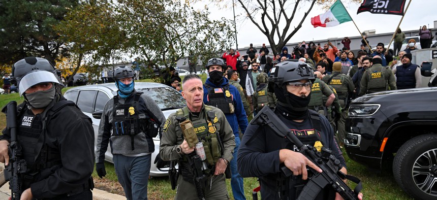 Residents and protesters demonstrate against Border Patrol actions on October 22, 2025, in Cicero, Illinois. 