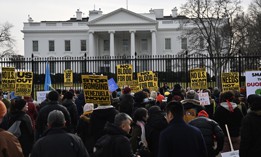 People carrying banners gather to protest the U.S. attacks on Venezuela, in Washington, D.C., on January 3, 2026.