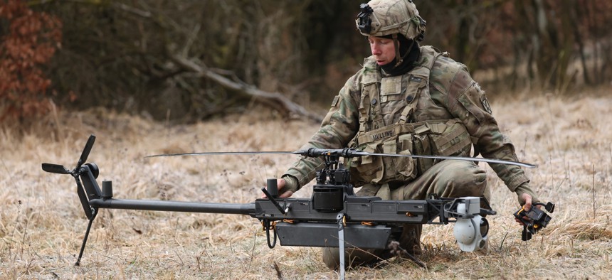A soldier with the U.S. Army's 10th Mountain Division readies an Anduril Ghost-X helicopter surveillance drone during the Combined Resolve 25-1 military exercises at the Hohenfels Training Area near Hohenfels, Germany, on February 3, 2025.