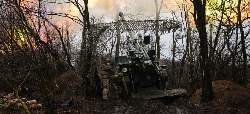 Soldiers of Ukraine's 148th Artillery Brigade fire toward Russian lines as others watch for hostile drones near Pokrovsk, Donetsk Region, Ukraine, on January 11, 2026. 