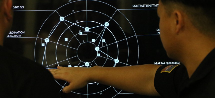 A clinical research coordinator explains the results of a sensory performance test to a soldier as a part of the Assessing and Tracking Tactical (ATTAC) Forces Initiative Mar. 30, 2023, at Fort Bragg, NC..