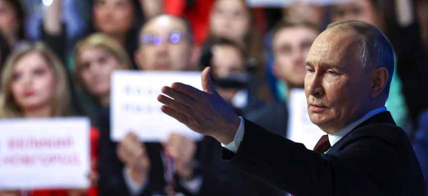 In this pool photograph distributed by the Russian state agency Sputnik, Russia's President Vladimir Putin holds his annual end-of-year press conference in Moscow on December 19, 2025.