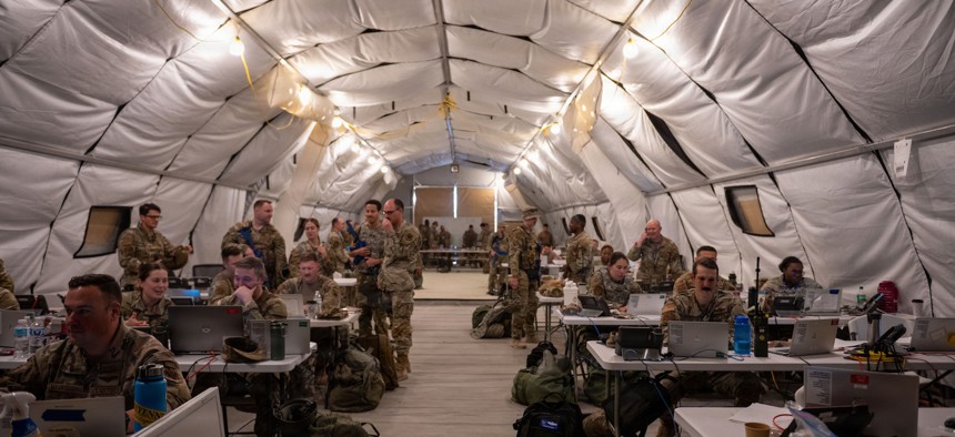 Airmen work inside a deployable Wing Operations Center, simulating operations in an austere environment at Tyndall Air Force Base, Florida, Nov. 19, 2025. 
