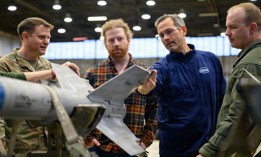 John Paul Mintz, Defense Advanced Research Projects Agency scientific engineering and technical adviser, discusses the systems on an AIM-9 Sidewinder missile with airmen during a tour at Spangdahlem Air Base, Germany, Jan. 29, 2026. 