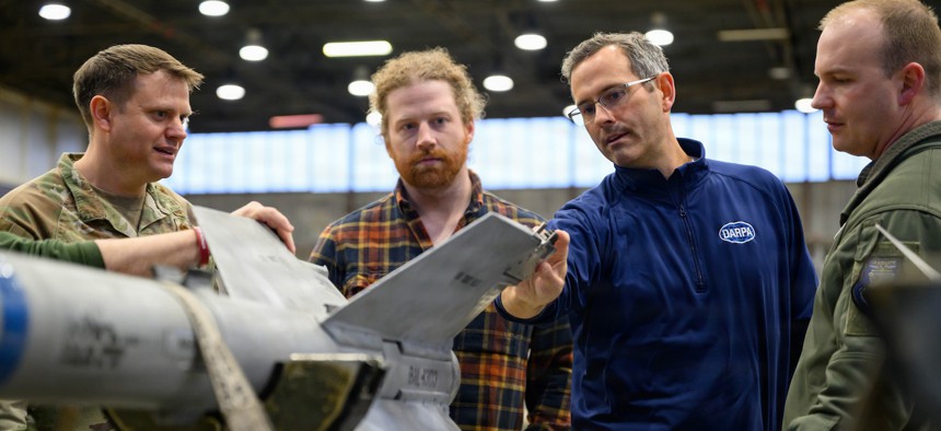John Paul Mintz, Defense Advanced Research Projects Agency scientific engineering and technical adviser, discusses the systems on an AIM-9 Sidewinder missile with airmen during a tour at Spangdahlem Air Base, Germany, Jan. 29, 2026. 
