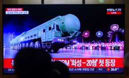 The 24-hour newsfeed at Seoul Railway Station showing a news broadcast with a Hwasong-20 Intercontinental Ballistic Missile (ICBM) display at Kim Il Sung Square in Pyongyang, North Korea.