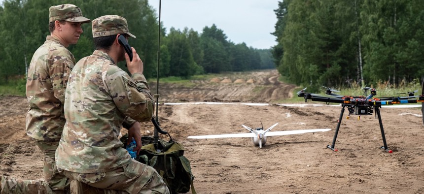 Soldiers assigned to 1st Armored Brigade Combat Team, 3rd Infantry Division, establish radio communications during Project Flytrap at Bemowo Piskie Training Area, Poland, July 27, 2025.