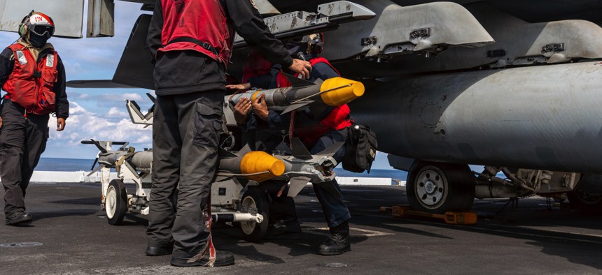 U.S. sailors load ordnance onto an F/A-18E Super Hornet aircraft aboard the aircraft carrier Gerald R. Ford for combat operations against Iran on March 1, 2026.