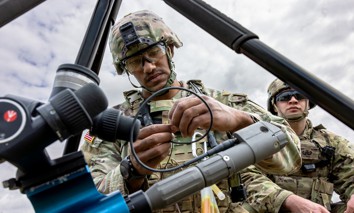 An explosive ordnance disposal soldier assembles a TiTAN disrupter system for unmanned aircraft system training at Balli Airfield, U.S. Army Garrison Bavaria, July 8, 2025. 