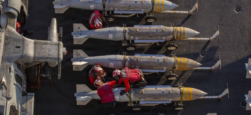 U.S. sailors prepare to stage ordnance on the flight deck of the USS Abraham Lincoln in support of Operation Epic Fury on February 28, 2026 