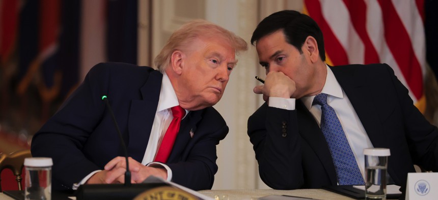 Secretary of State Marco Rubio speaks to President Donald Trump during a roundtable discussion on college sports in the East Room of the White House on March 6, 2026, in Washington, D.C. 