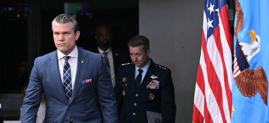 Defense Secretary Pete Hegseth and Chairman of the Joint Chiefs of Staff General Dan Caine arrive for a news conference at the Pentagon on March 19, 2026.