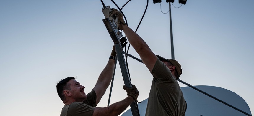 Guardians work on a 1.8-meter parabolic antenna in the U.S. Central Command area of responsibility, Nov. 26, 2024.