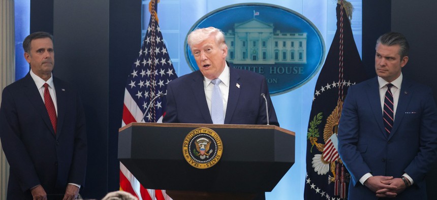President Donald Trump speaks alongside Central Intelligence Agency Director John Ratcliffe (L) and Defense Secretary Pete Hegseth during a news conference at the White House.