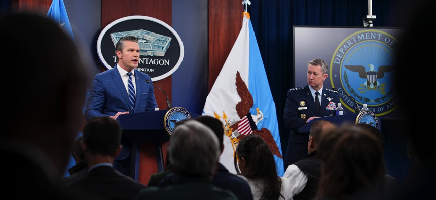 U.S. Secretary of War Pete Hegseth (L) speaks as Chairman of the Joint Chiefs of Staff Gen. Dan Caine looks on during a press briefing at the Pentagon on April 8, 2026.