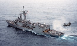 The guided missile frigate Samuel B. Roberts, down at the stern after being severely damaged by an Iranian mine in the Persian Gulf, is towed to Dubai for repairs on April 15, 1988.
