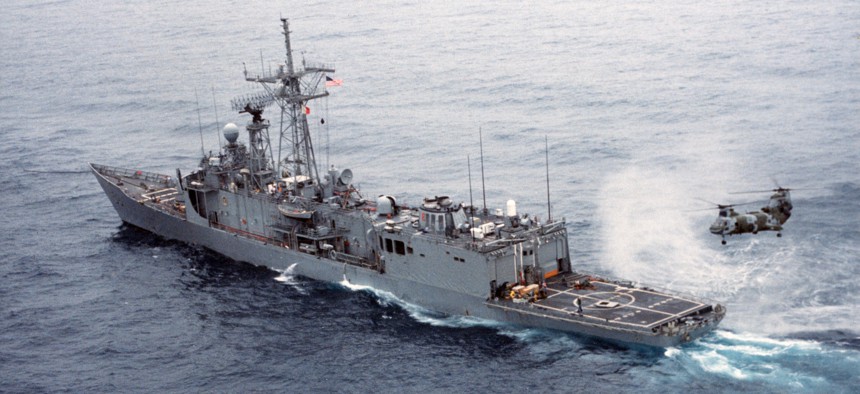 The guided missile frigate Samuel B. Roberts, down at the stern after being severely damaged by an Iranian mine in the Persian Gulf, is towed to Dubai for repairs on April 15, 1988.