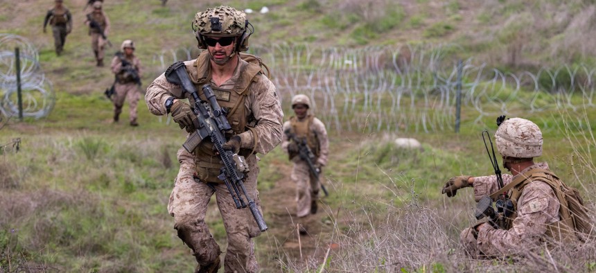 Marines with Blackfoot Company, 1st Battalion, 5th Marine Regiment, 1st Marine Division, close in on an objective during a combat readiness evaluation at Marine Corps Base Camp Pendleton, California, Dec. 14, 2025.