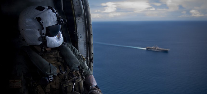 Naval Air Crewman (Helicopter) 2nd Class Chris Sanderson observes the Boxer Amphibious Ready Group transiting the Sulu Sea from an MH-60S Sea Hawk, April 26, 2026.