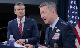 Defense Secretary Pete Hegseth looks on as Chairman of the Joint Chiefs of Staff Gen. Dan Caine speaks during a press briefing at the Pentagon on May 5, 2026.