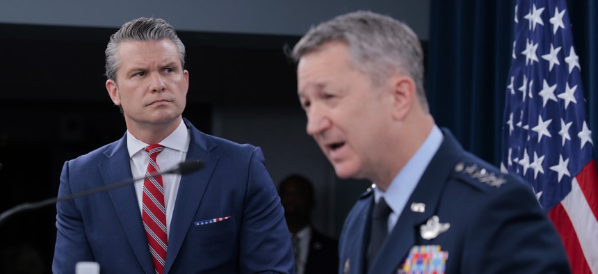 Defense Secretary Pete Hegseth looks on as Chairman of the Joint Chiefs of Staff Gen. Dan Caine speaks during a press briefing at the Pentagon on May 5, 2026.