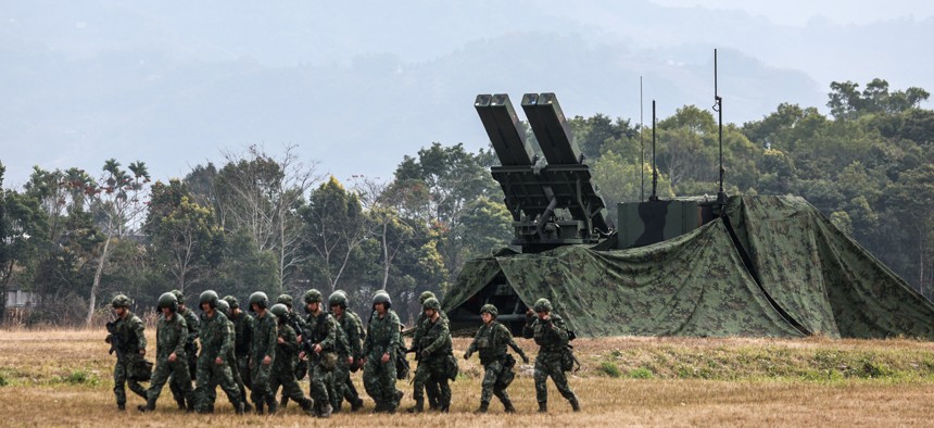 Taiwanese soldiers walk past a Sky Sword II Land-based Air Defence Missile launcher in Taichung, Taiwan, on January 27, 2026.