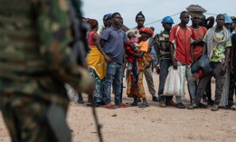Displaced Burundian nationals line up as they remain stranded on the Congolese side after the closure of the border between the Democratic Republic of Congo and Burundi at the Kavimvira border post on December 14, 2025. 