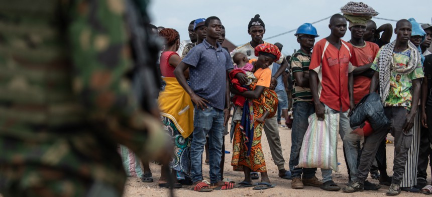 Displaced Burundian nationals line up as they remain stranded on the Congolese side after the closure of the border between the Democratic Republic of Congo and Burundi at the Kavimvira border post on December 14, 2025. 