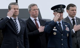 Defense Secretary Pete Hegseth, Army Secretary Dan Driscoll, and Joint Chiefs Chairman Gen. Dan Caine stand at attention as U.S. troops killed in the Iran war are brought home through Dover Air Force Base on March 7, 2026.