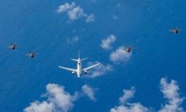 A Royal Australian Air Force E-7A Wedgetail is flanked from left to right by a RAAF F-35A Lightning II, a U.S. Air Force F-35A, a Japan Air Self Defense Force F-35A and a U.S. Marine Corps F-35B Lightning II over the U.S. Indo-Pacific Command area of responsibility, Feb. 7, 2025.