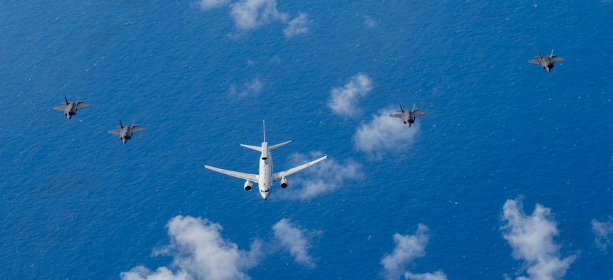 A Royal Australian Air Force E-7A Wedgetail is flanked from left to right by a RAAF F-35A Lightning II, a U.S. Air Force F-35A, a Japan Air Self Defense Force F-35A and a U.S. Marine Corps F-35B Lightning II over the U.S. Indo-Pacific Command area of responsibility, Feb. 7, 2025.