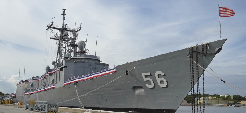Sailors man the rails of the guided-missile frigate USS Simpson during its decommissioning ceremony in 2015.