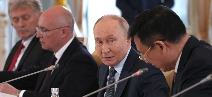 Russian President Vladimir Putin speaks to Xinhua News Agency chief Fu Hua on the sidelines of the St. Petersburg International Economic Forum in Saint Petersburg on June 4, 2026. 