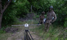 A view of two Ukrainian soldiers with a VB140 interceptor drone on a catapult launcher near the frontline on the outskirts of the city of Sumy, northeastern Ukraine, on June 13, 2026.