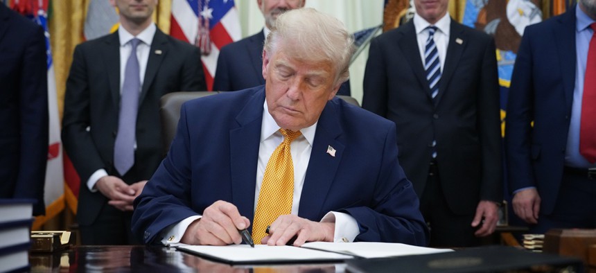 President Donald Trump signs an executive order in the Oval Office of the White House on June 22, 2026 in Washington, DC.