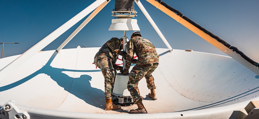 Guardians swap an antenna feed on top of a large multi-band antenna in the U.S. Central Command area of responsibility, Nov. 25, 2024.