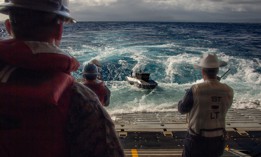 An autonomous Typhoon surface vessel delivers parts for the 3D printer aboard the USS Essex, during RIMPAC 2026, July 7, 2026.