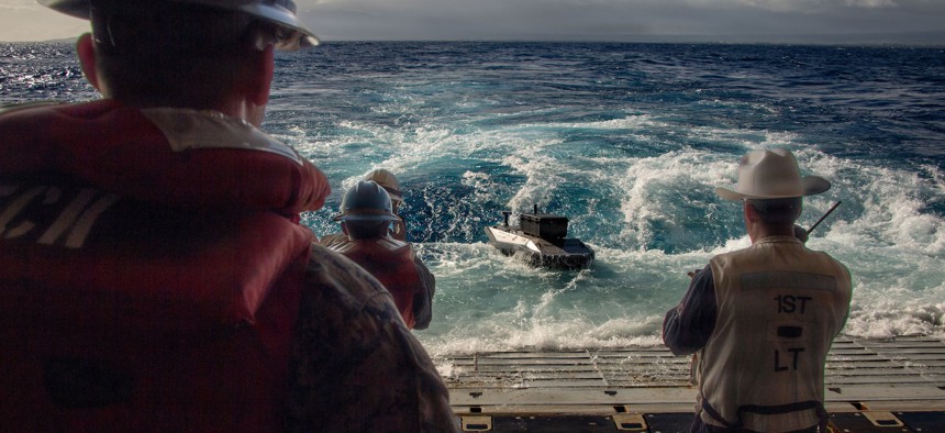 An autonomous Typhoon surface vessel delivers parts for the 3D printer aboard the USS Essex, during RIMPAC 2026, July 7, 2026.