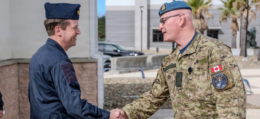 Royal Canadian Armed Forces Maj. Gen. Kyle Paul, allied deputy combined joint force space component commander, shakes hands with Swedish Armed Forces Rear Adm. Anders Sundeman, chief of space, at Vandenberg Space Force Base, Calif., May 4, 2026.
