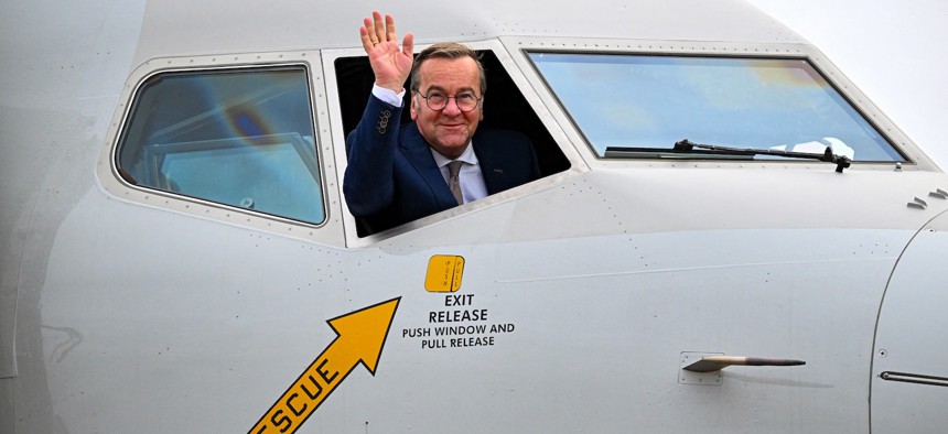 German Defence Minister Boris Pistorius waves out of the cockpit window of a Boeing P-8 Poseidon at the BER Airport in Schoenefeld, Germany, on June 12, 2026.